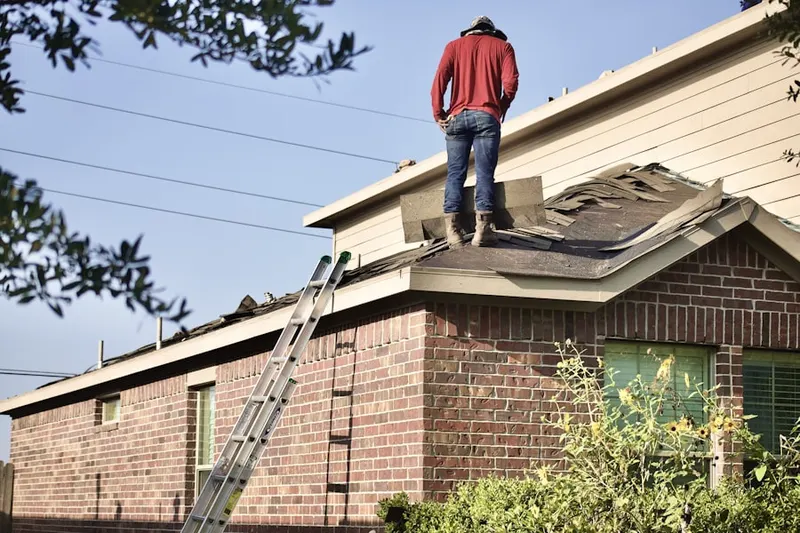Professional roofer working on a residential roof in Cumberland Hills